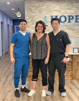 Therapist and patient smiling together during visit at HOPE Clinic lobby