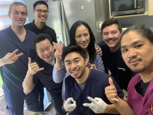 HOPE Clinic team group selfie with peace signs in break room