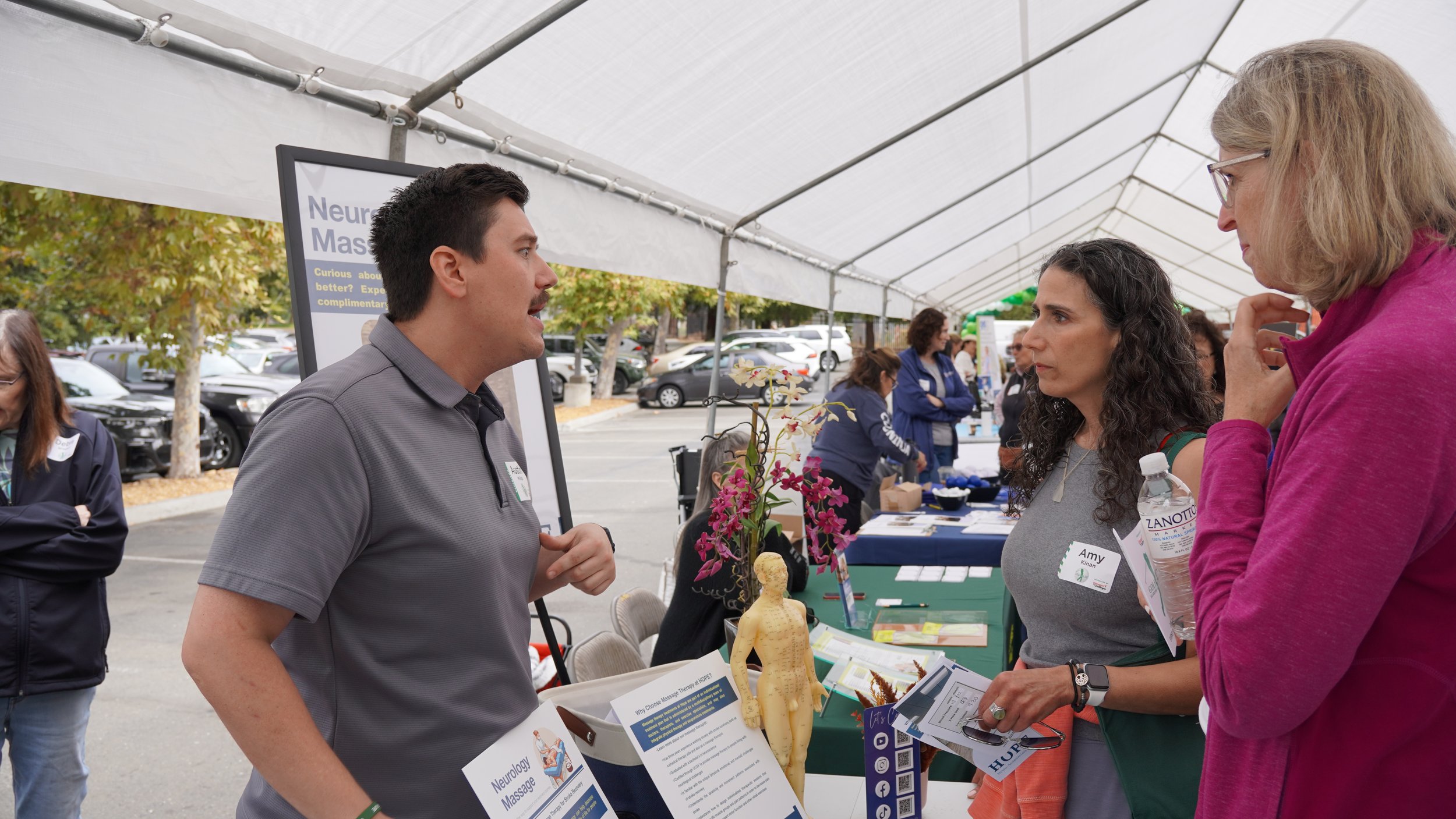 Dr. Lu and staff posing with patient visitors in HOPE Clinic treatment area