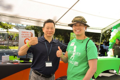 Dr. Lu giving thumbs up with community supporter at stroke awareness fundraiser