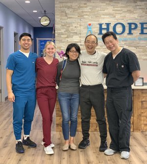 HOPE Clinic team posing with patient in lobby