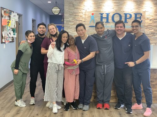 HOPE Clinic team posing with recovered patient in lobby