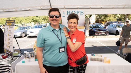 HOPE Clinic staff member and visitor posing at community stroke awareness event